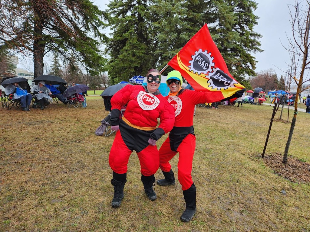 Two people in Incledibles costumes on the PSAC picket line.