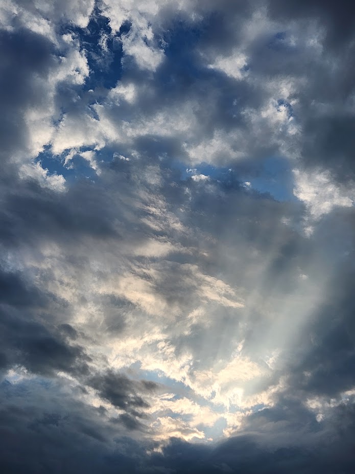 Picture of clouds with crepuscular rays.